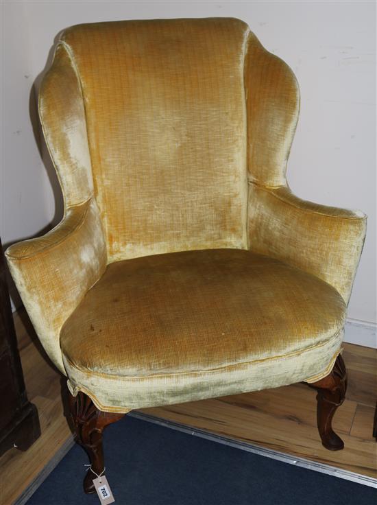 A Queen Anne style carved walnut wing chair, on shell-carved cabriole legs